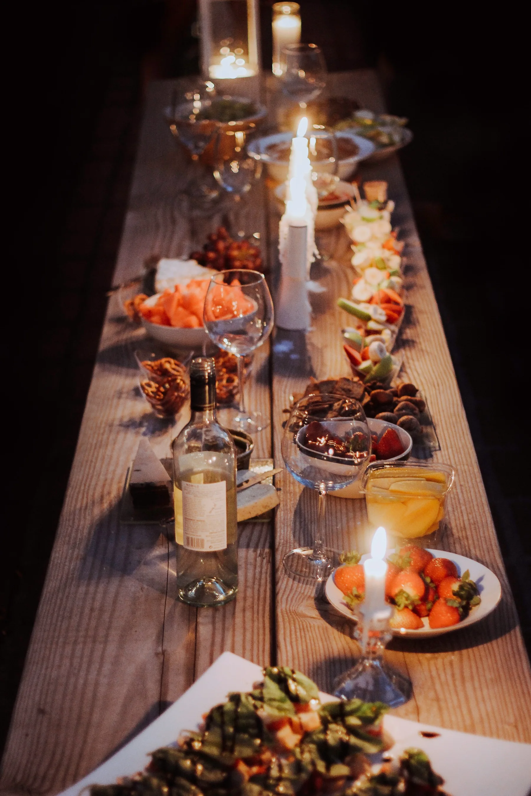 A long table laid with candles before guests arrive